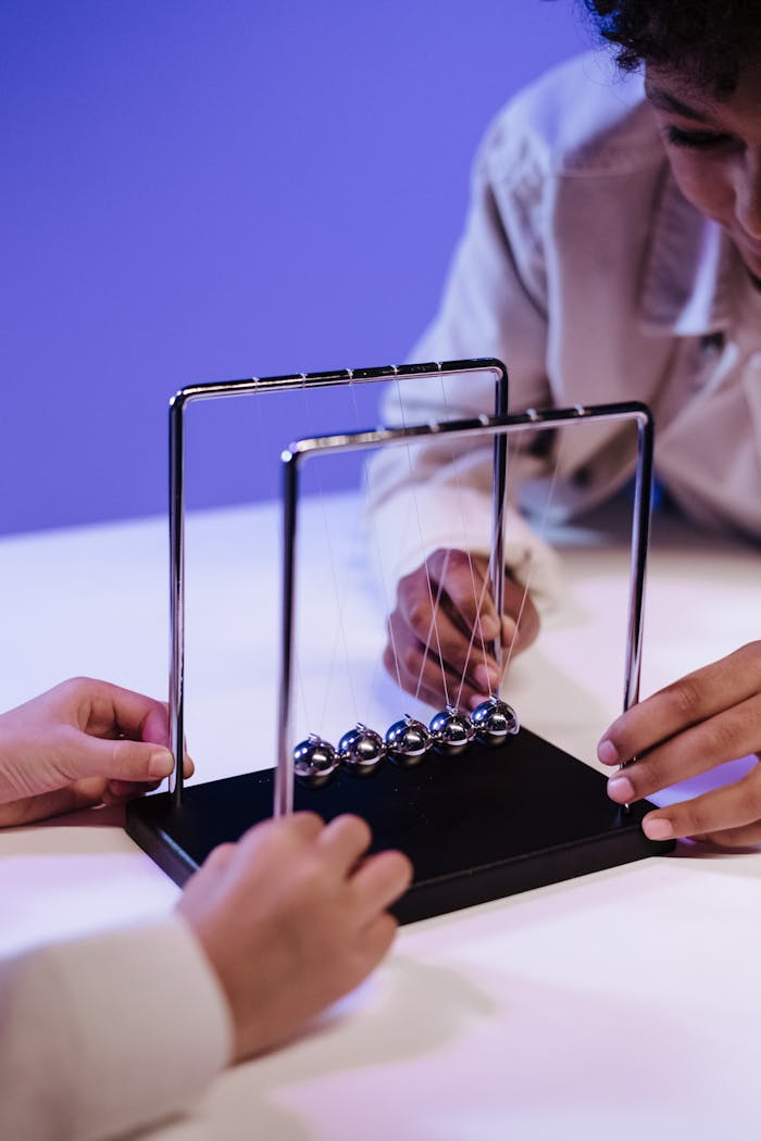 Children playing with newton s cradle